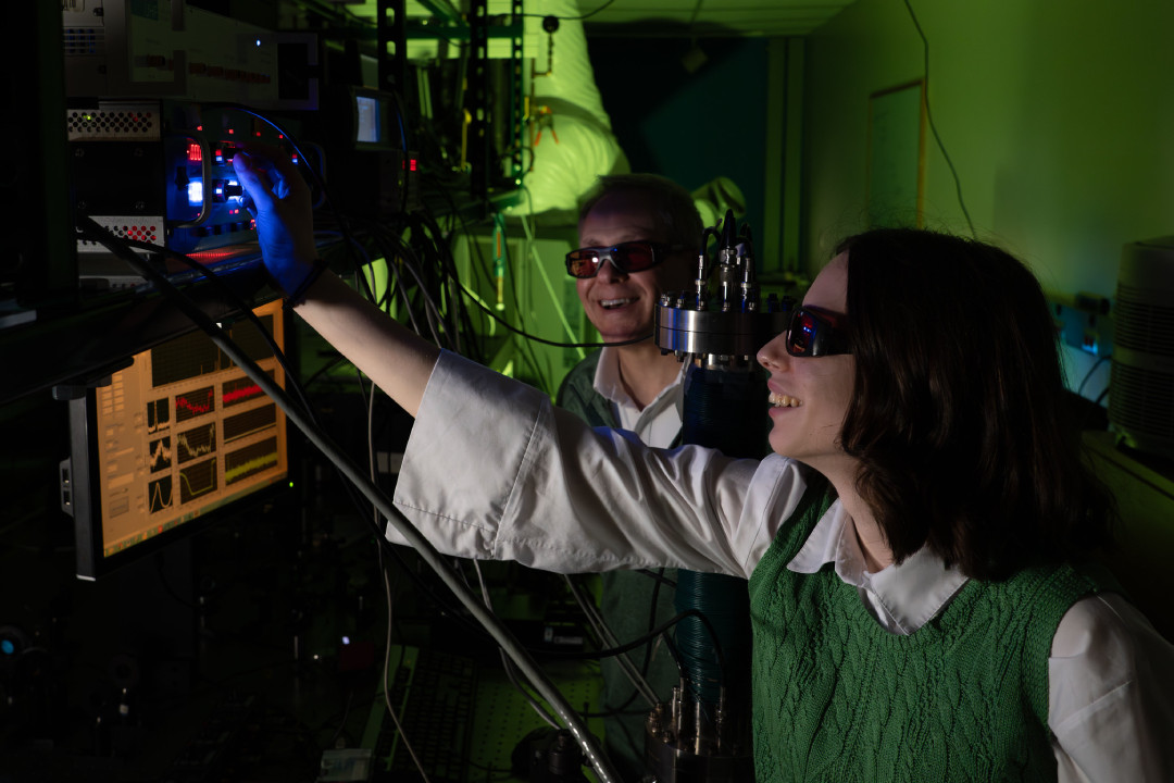Faculty member and student working with laser lab equipment