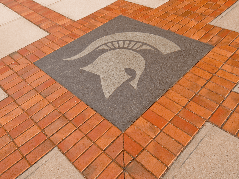 spartan logo in brick and stone walkway