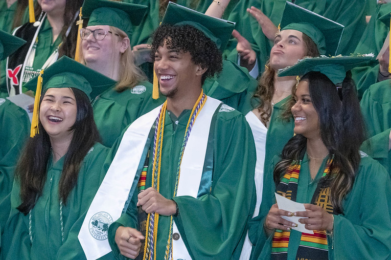 A group of students wearing caps and gowns at commencement