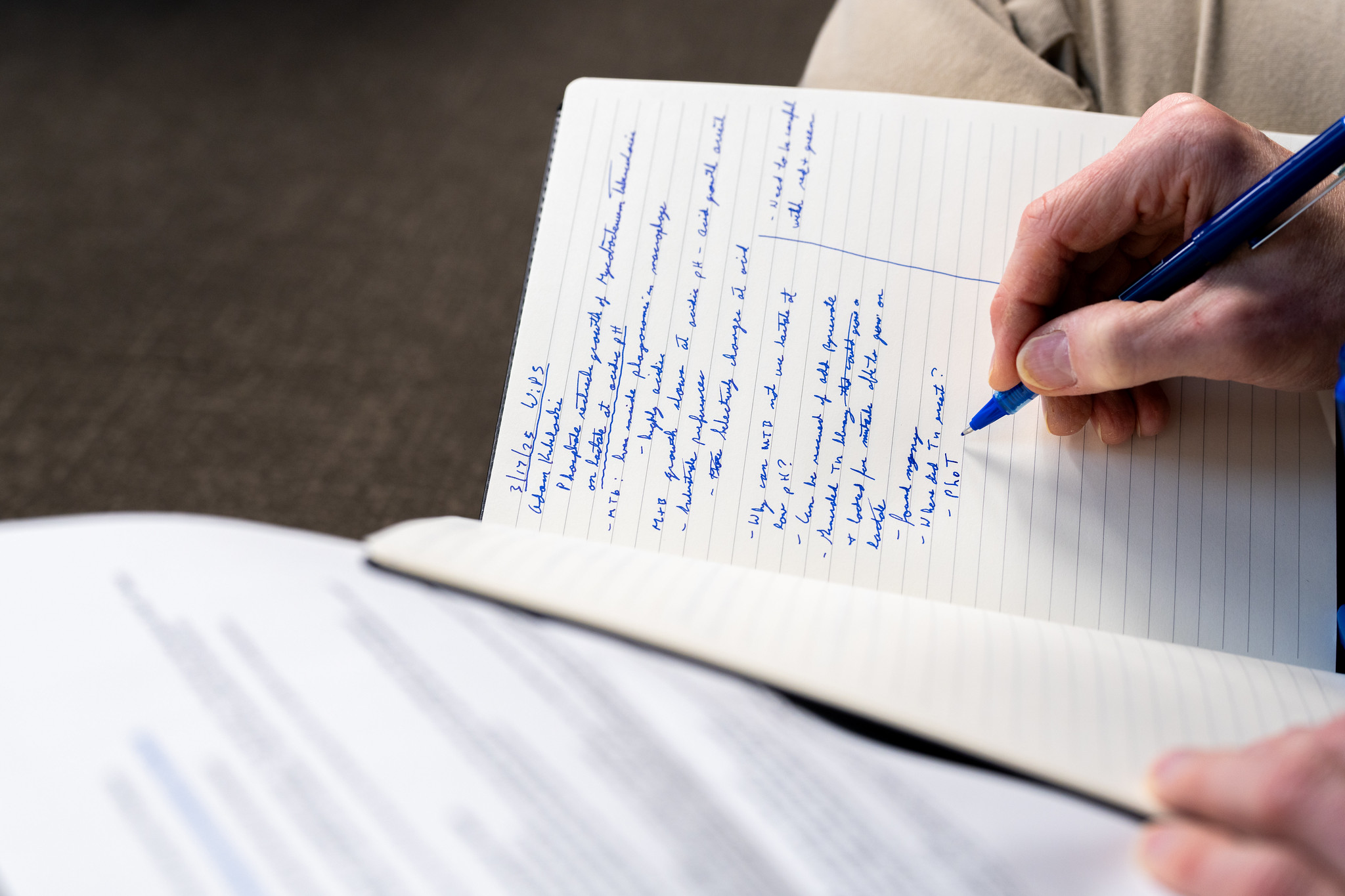 person writing in a notebook