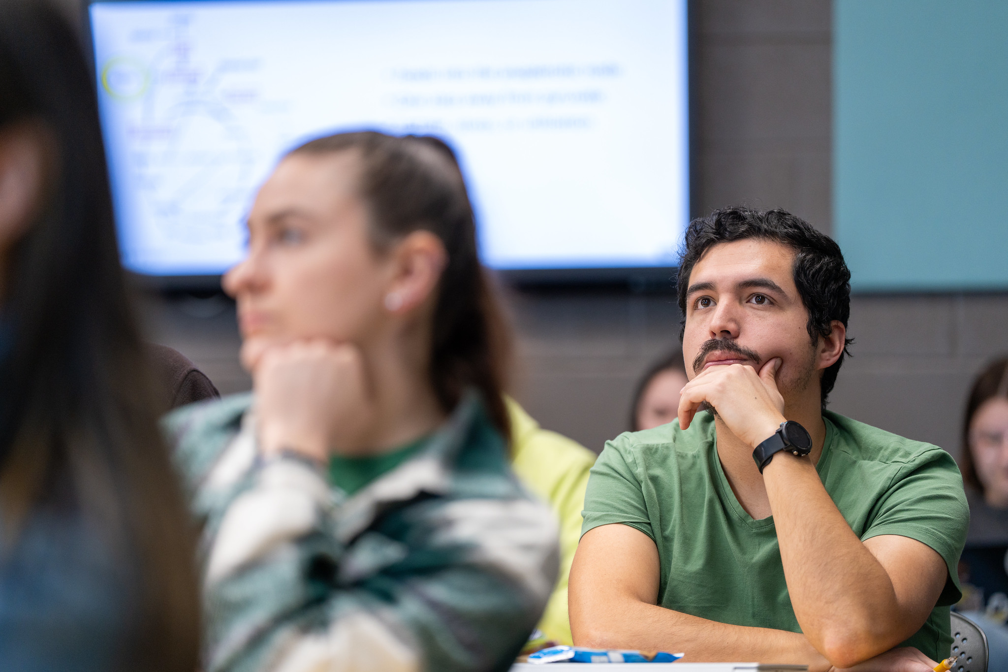 student focused listening sitting down at a desk