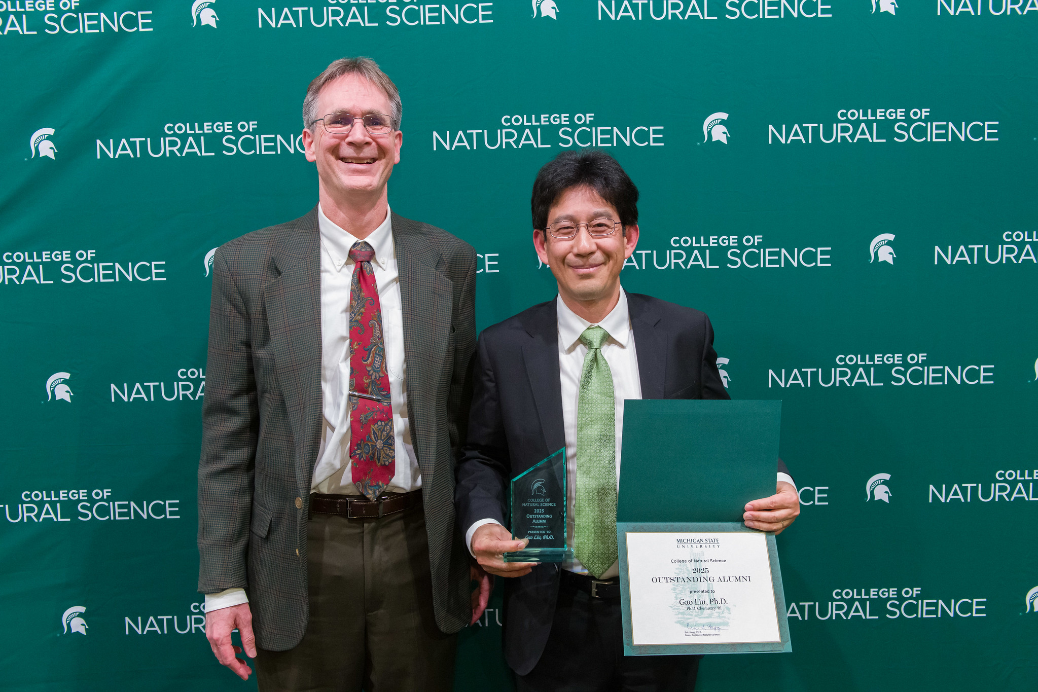 NatSci Dean at awards ceremony standing at pdoium