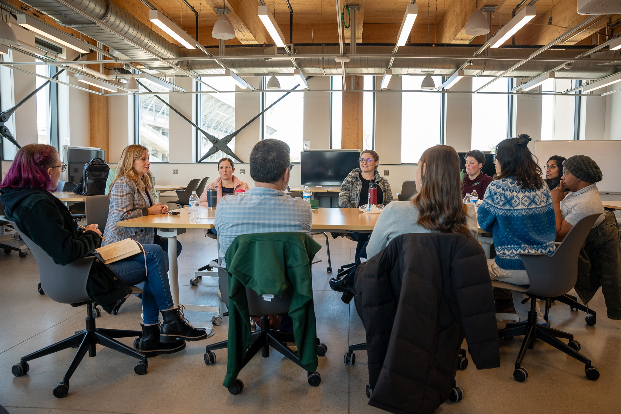 image of two people talking at a desk across from each other
