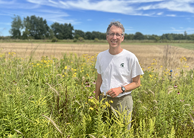 Nick Haddad standing in a prairie strip at the LTER site located at MSU's Kellogg Biological Station.