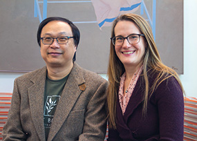 MSU College of Natural Science plant biologists Andrea Case and Shinhan Shiu sitting on a couch at the MSU Library to pose for a photo of them as 2022 AAAS Fellows..