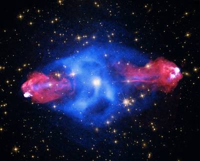The galaxy Cygnus A is seen at the center of this image shrouded in plasma (shown as a concentrated blue mass) with high-energy jets (shown in red toward the outside of the plasma) shooting from the galaxy’s central black hole. 
