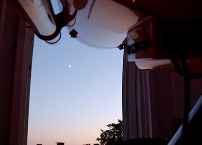 A view of the moon through the open dome of the MSU Observatory. Caption/alt text: A view of the moon through the open dome of the MSU Observatory. 