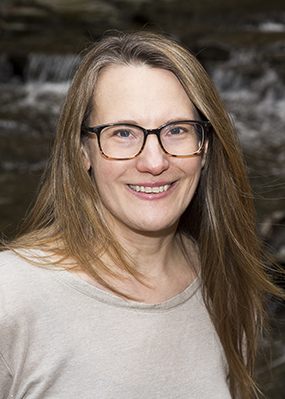 Headshot of Andrea Case, professor and chair of the MSU Department of Plant Biology in the College of Natural Science. She is wearing glasses and a light beige shirt.