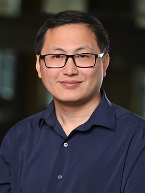 Headshot of Tuo Wang in a navy blue shirt.