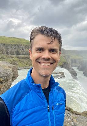 Anthony Kendall, assistant professor, MSU Department of Earth and Environmental Sciences, in a blue jacket vest standing in front of Gullfoss waterfall, located in South Iceland on the Hvita River.