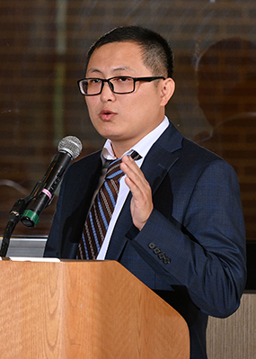 Tuo Wang at a podium giving his research presentation during his investiture as the inaugural Carl H. Brubaker, Jr. Endowed Professor.