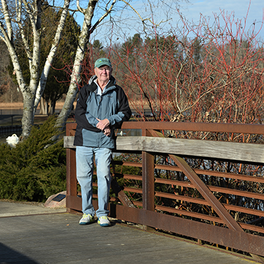 David Dvorak stands on the KBS Bird Sanctuary bridge that he helped establish