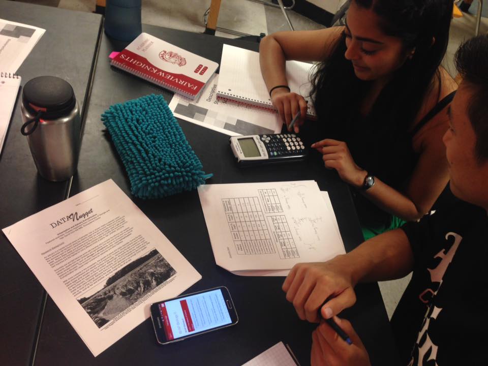 High school students work with a Data Nuggets module.