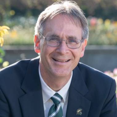 Dean Eric Hegg sits on a bench