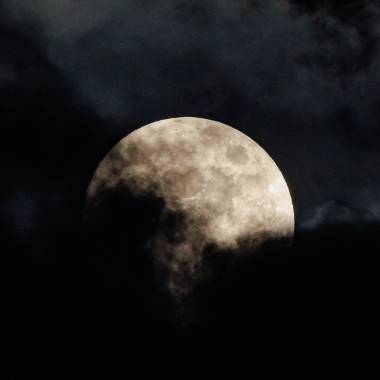 A full moon with cloud cover