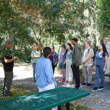 Students listen to a man talking at a graduate student gathering