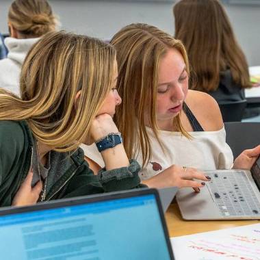 Two students look at a computer