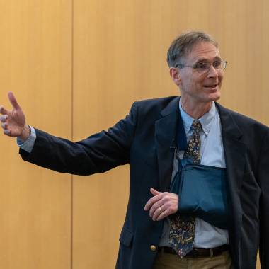 Eric Hegg gestures while giving a presentation.