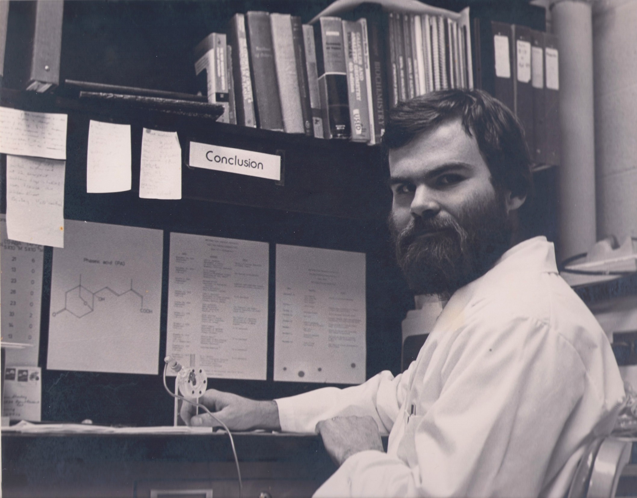 A photo from the late 70s of Tom Sharkey sitting at a desk.