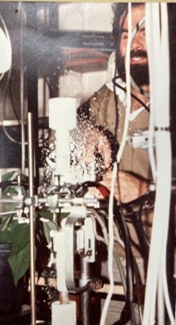 A man builds a piece of machinery, sparks flying