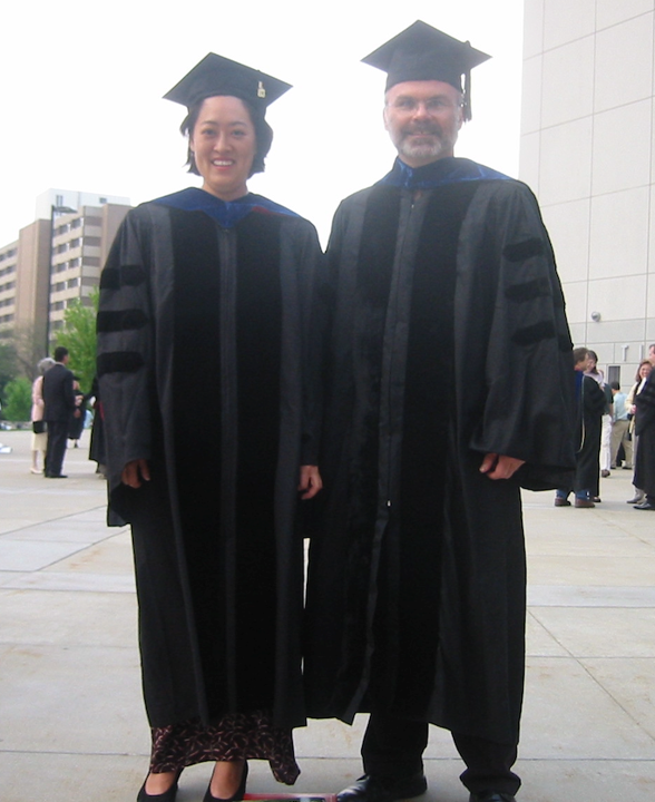 Two people in graducation cap and gown