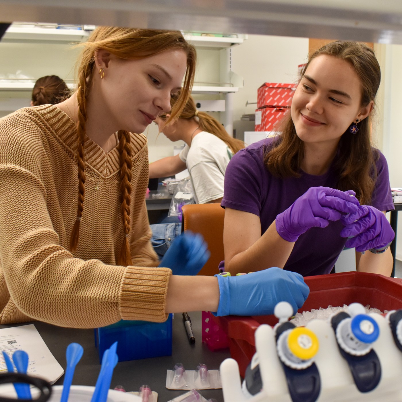 Two students work in a lab
