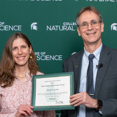 Phoebe Zarnetski and Dean Eric Hegg hold a certificate.