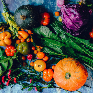 An arrangement of leafy greens, gourds and vegetables