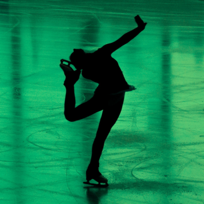 Ice skater holding a position while skating on green ice