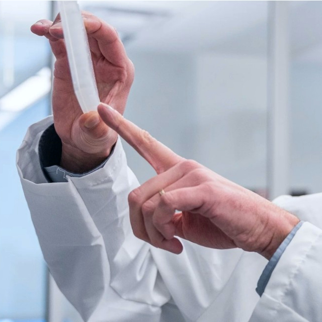 flat container held up in air with finger pointing at a specific area