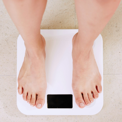 top down angle of person standing on a weight scale