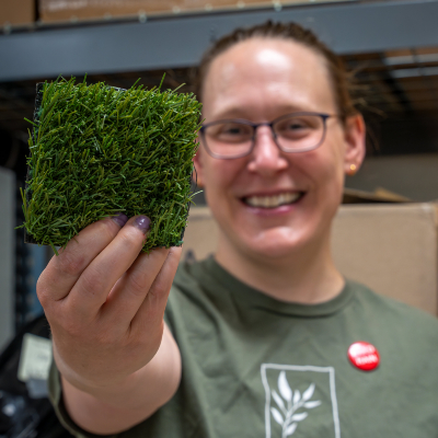 Sullivan holds a grass plot out to the viewer