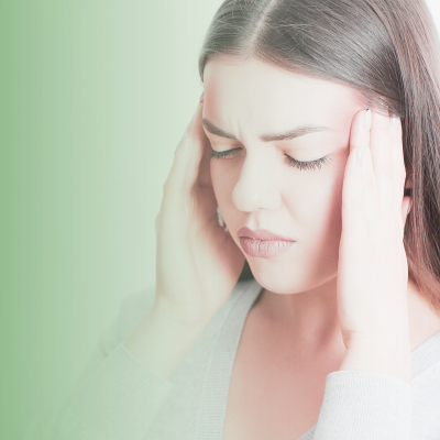 Woman with eyes closed, holding the sides of her head