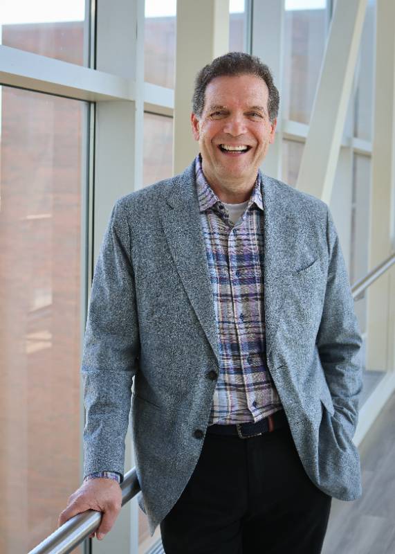 photo of Victor DiRita wearing a blue sport coat and standing by a window.