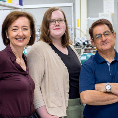 3 people stand next to each other in a lab