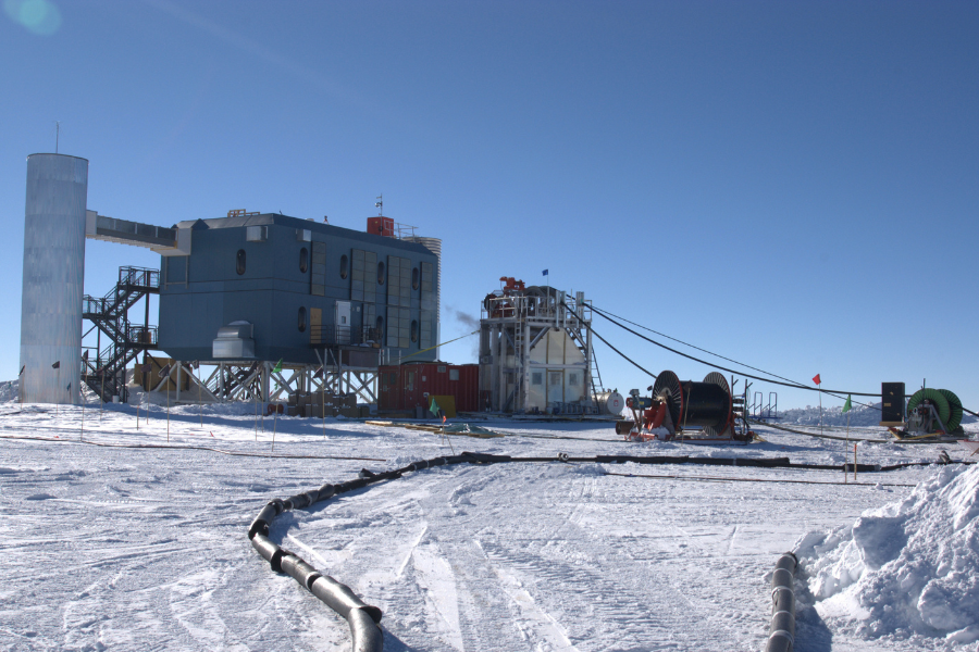 Block building with cables stretching into areas around it, in the middle of snow covered plain.