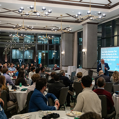 Photo of crowd listening to a talk at the 2025 Simon Lecture. 