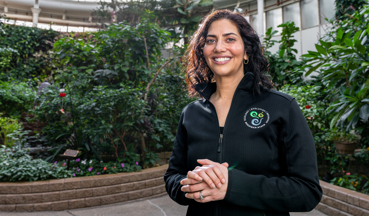portrait of elise zipkin in a greenhouse surrounded by plants