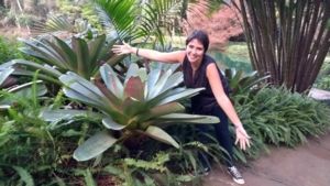 Image of Isabela BOrges next to a bromeliad in Brazil