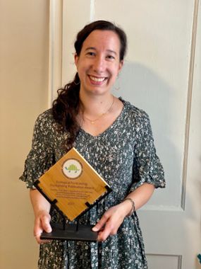 Sarah Saunders holding the Ecological Forecasting Outstanding Publication Award from the Ecological Society of America (ESA).