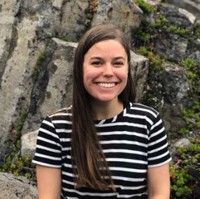 Mary Sabuda sitting on a rock formation.