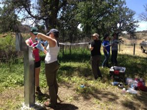 Putman and Sabuda at the well head at the site, retrieving hydrological data from dataloggers deployed in the subsurface. 