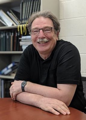 Christoph Benning sitting at his desk.