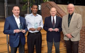 Award winners Ed Brown, Mark Ondari and James Hoeschle with Phil Duxbury posing with their awards at MSU's Wharton Center.