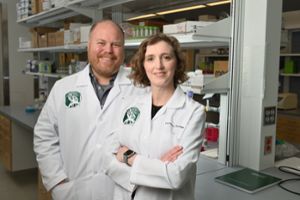 A.J. Robison and Michelle Mazei-Robison, also an associate professor in the Department of Physiology, pose together in their lab for a photo.